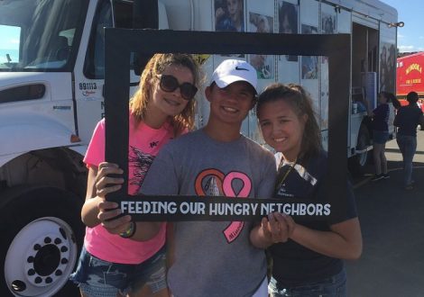 Students volunteer at food truck in Minooka to feed struggling families.