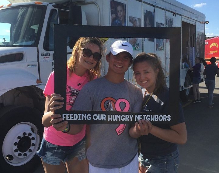 Students volunteer at food truck in Minooka to feed struggling families.